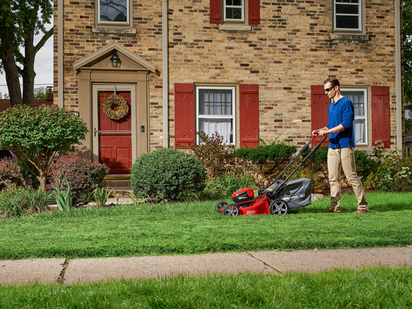 Person pushing a Snapper 82v battery mower