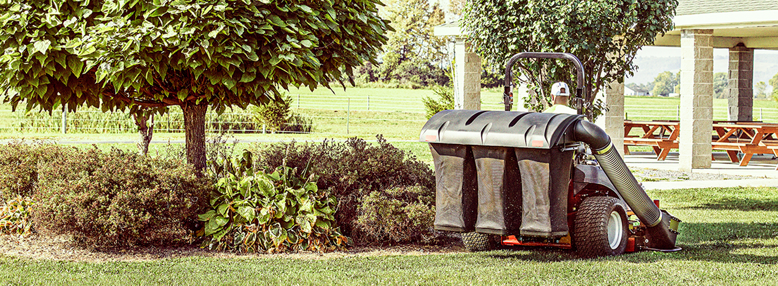 Landscaper riding zero turn mower with grass catcher attachment