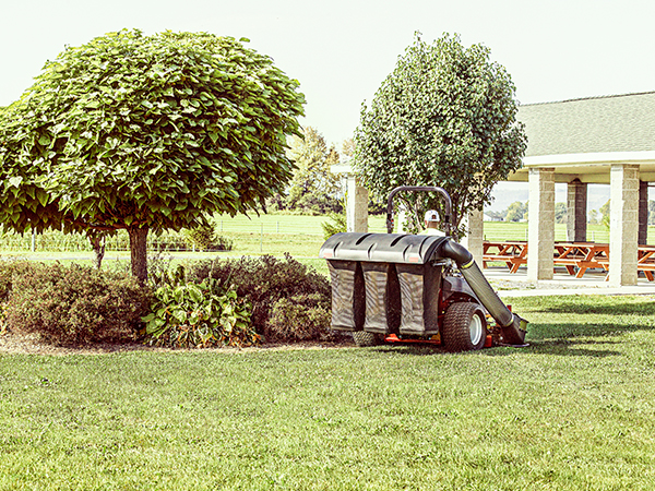 Landscaper riding zero turn mower with grass catcher attachment