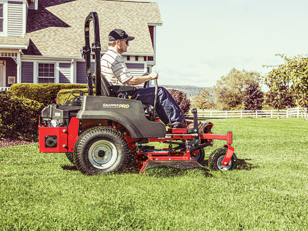 Man cutting grass with Snapper Pro zero turn mower