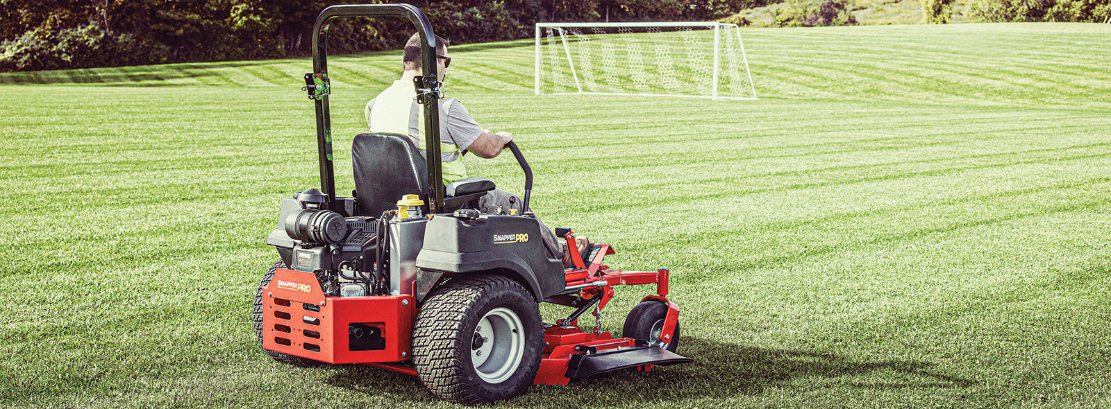 Landscaper mowing a field with a Snapper Pro Zero Turn Mower