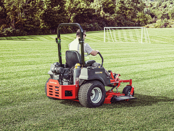 Landscaper mowing a field with a Snapper Pro Zero Turn Mower