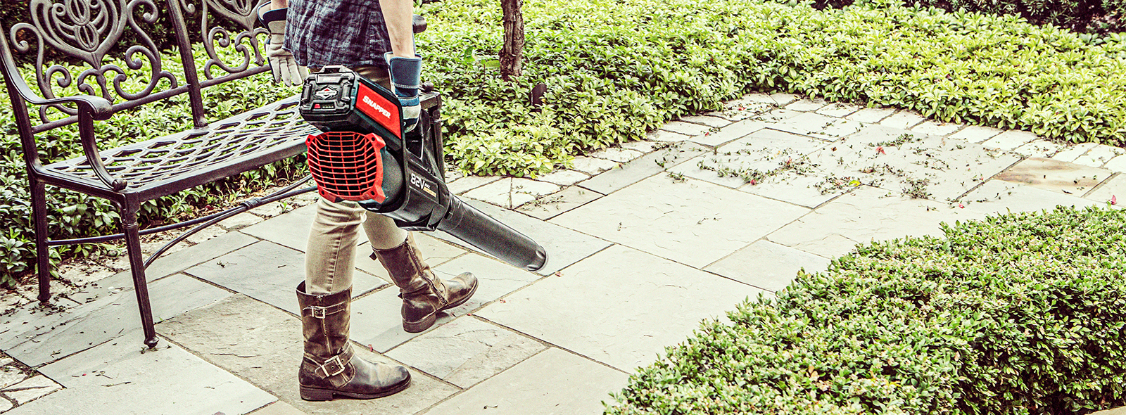 Women blowing off a patio with an electric leaf blower