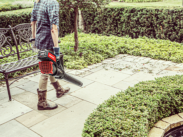 Women blowing off a patio with an electric leaf blower