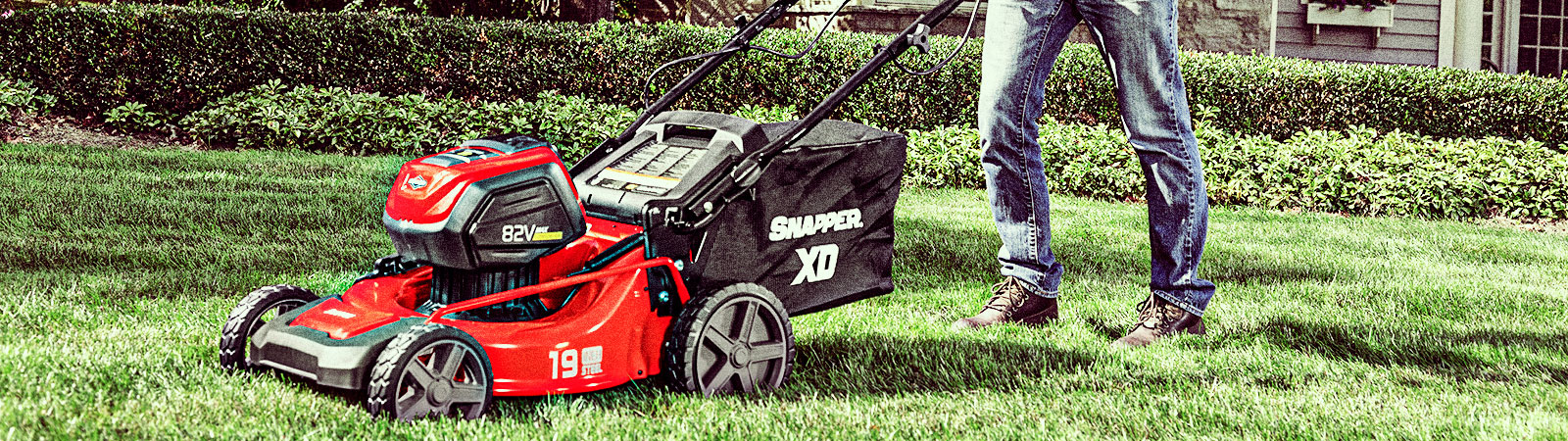 Person pushing a Snapper 82v battery mower